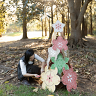 woman building a cardboard Christmas tree